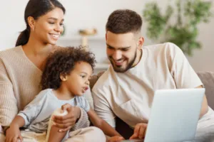 Family with laptop on couch, reviewing child tax credit info