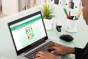 A woman uses a laptop to view her credit report online