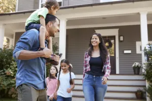 A young family in front of the house.