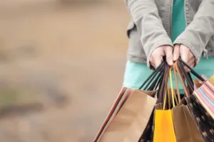 Hand holding multiple shopping bags