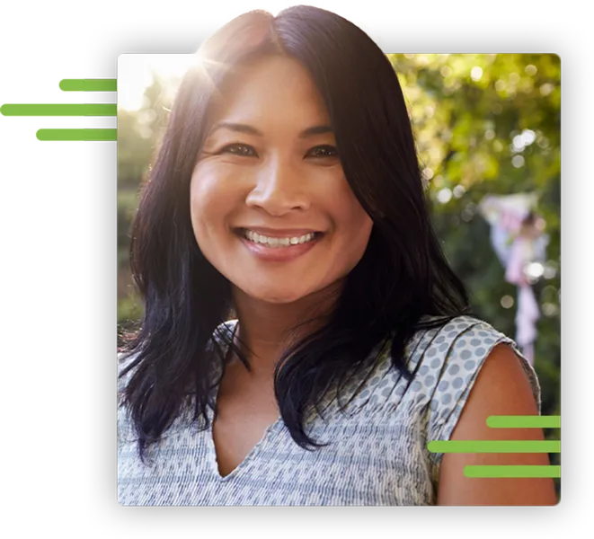 Diverse woman smiling at camera with sun and trees in the background