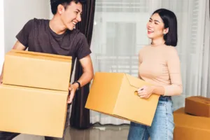 Young couple with boxes, moving into first home