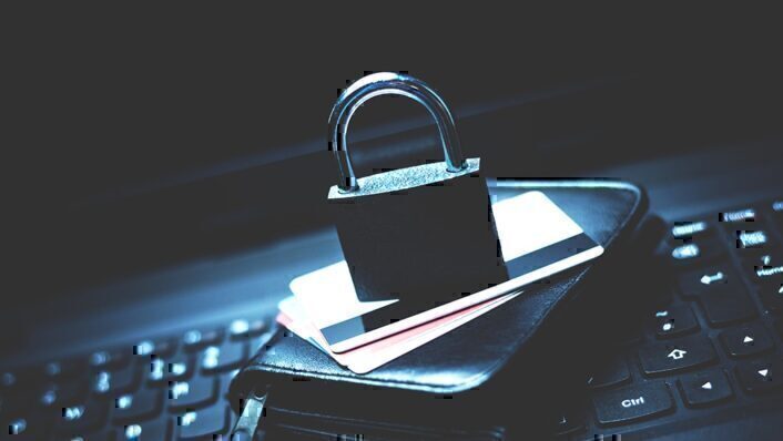 lock sitting on top of a stack of credit cards and cell phone