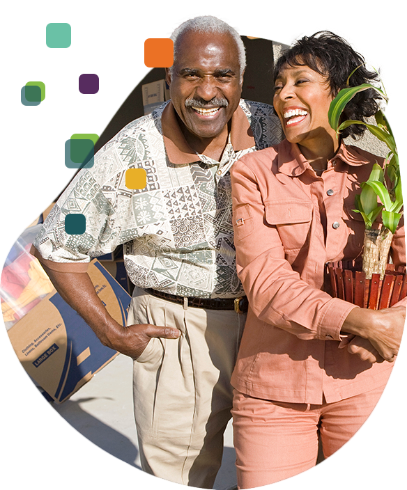 A senior couple holding a pot of plant.