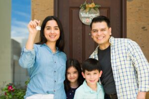a family standing infront of their new home