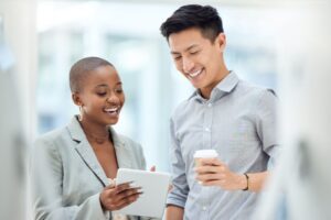 Two colleagues looking at a tablet.