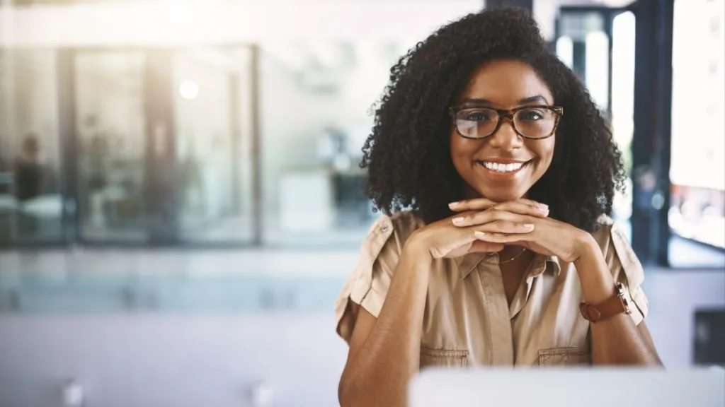 Woman in glasses smiling at camera.