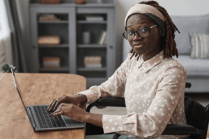 Woman in Wheel Chair Using Laptop