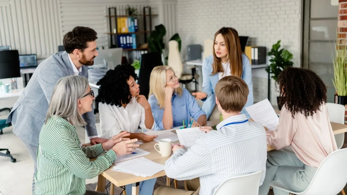 a group of diverse professionals meeting around a table
