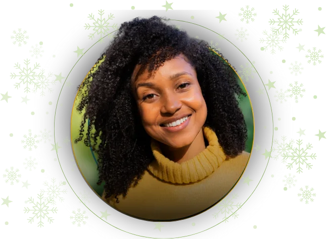 woman with tight curly hair wearing a yellow turtle neck sweater smiling at the camera