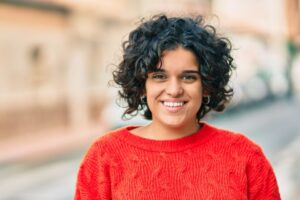 Smiling woman standing in the street.