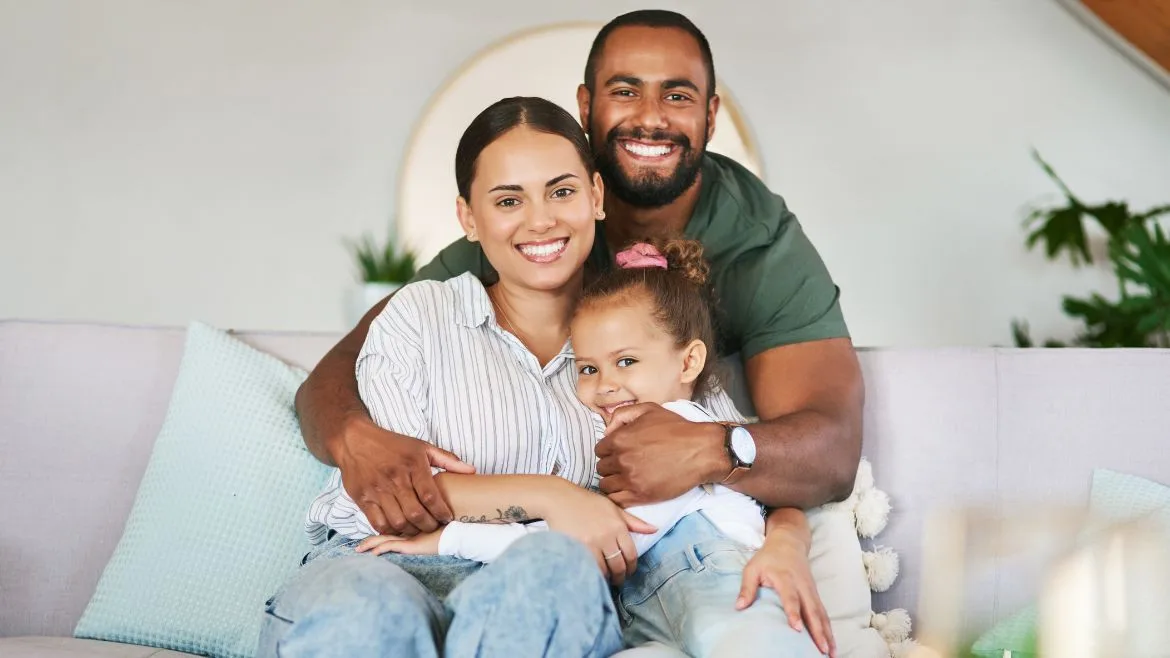 A diverse family of three with mom, dad and daughter.